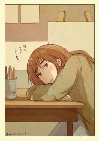 机に伏せる女性のイラスト。