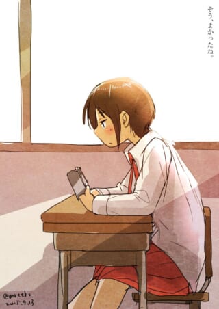 教室でスマホを見る女子学生