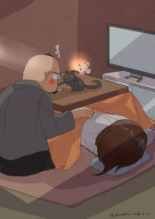 男性と猫とこたつのシーン。