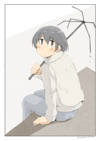 傘を持つ子供が振り返る。