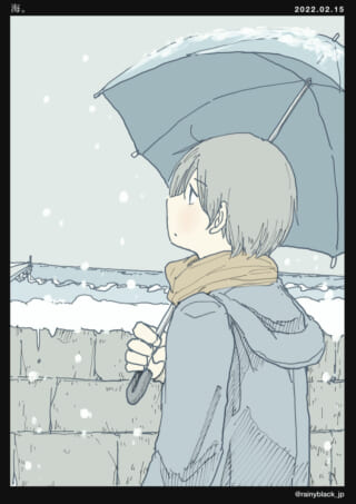 雪の日、傘をさす少年。
